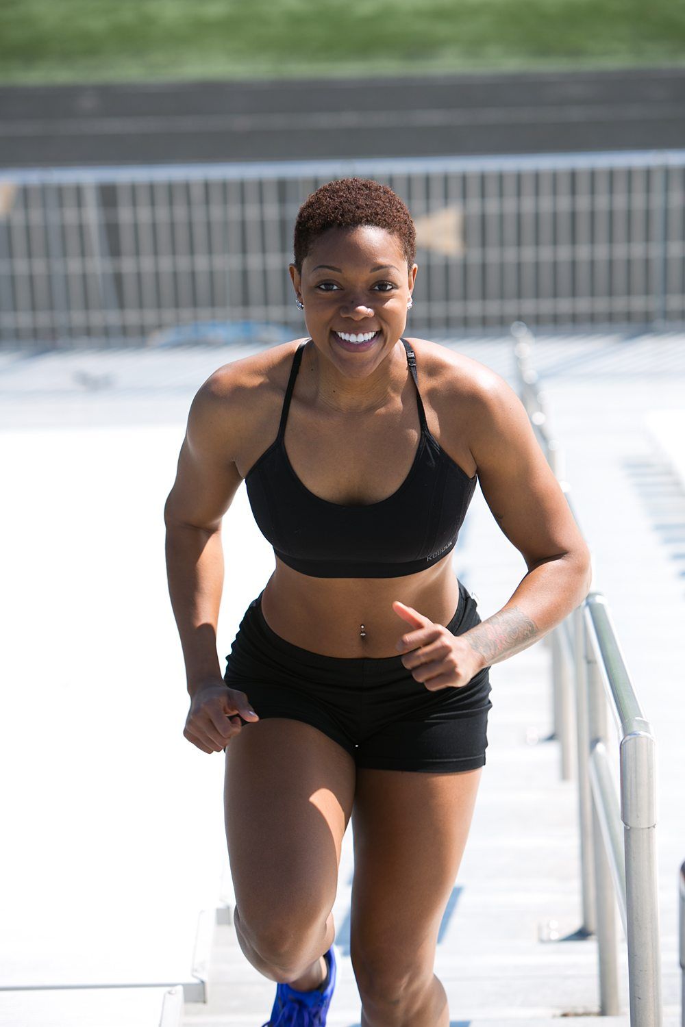 Smiling woman running up outdoor stairs