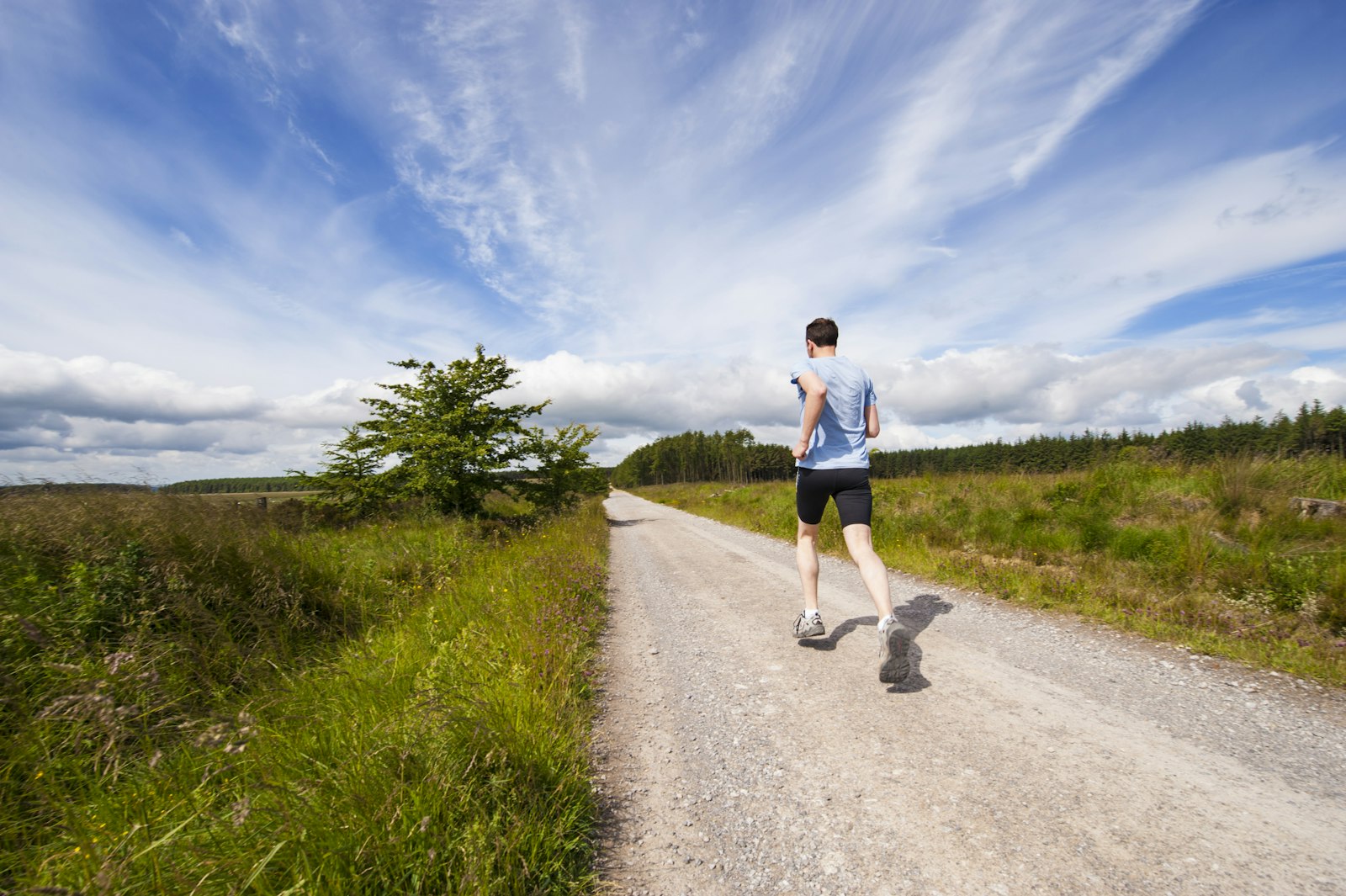Person running on a green country path